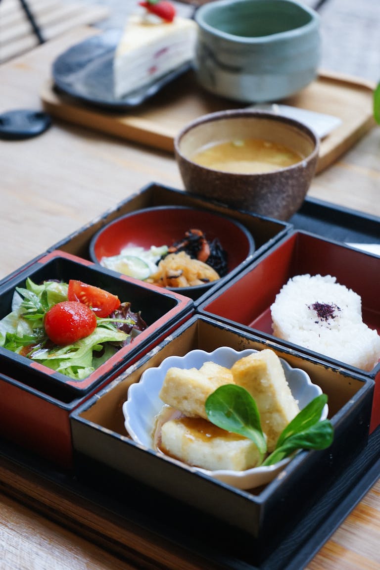 Delicious Japanese bento box with miso soup and salad served in Berlin.